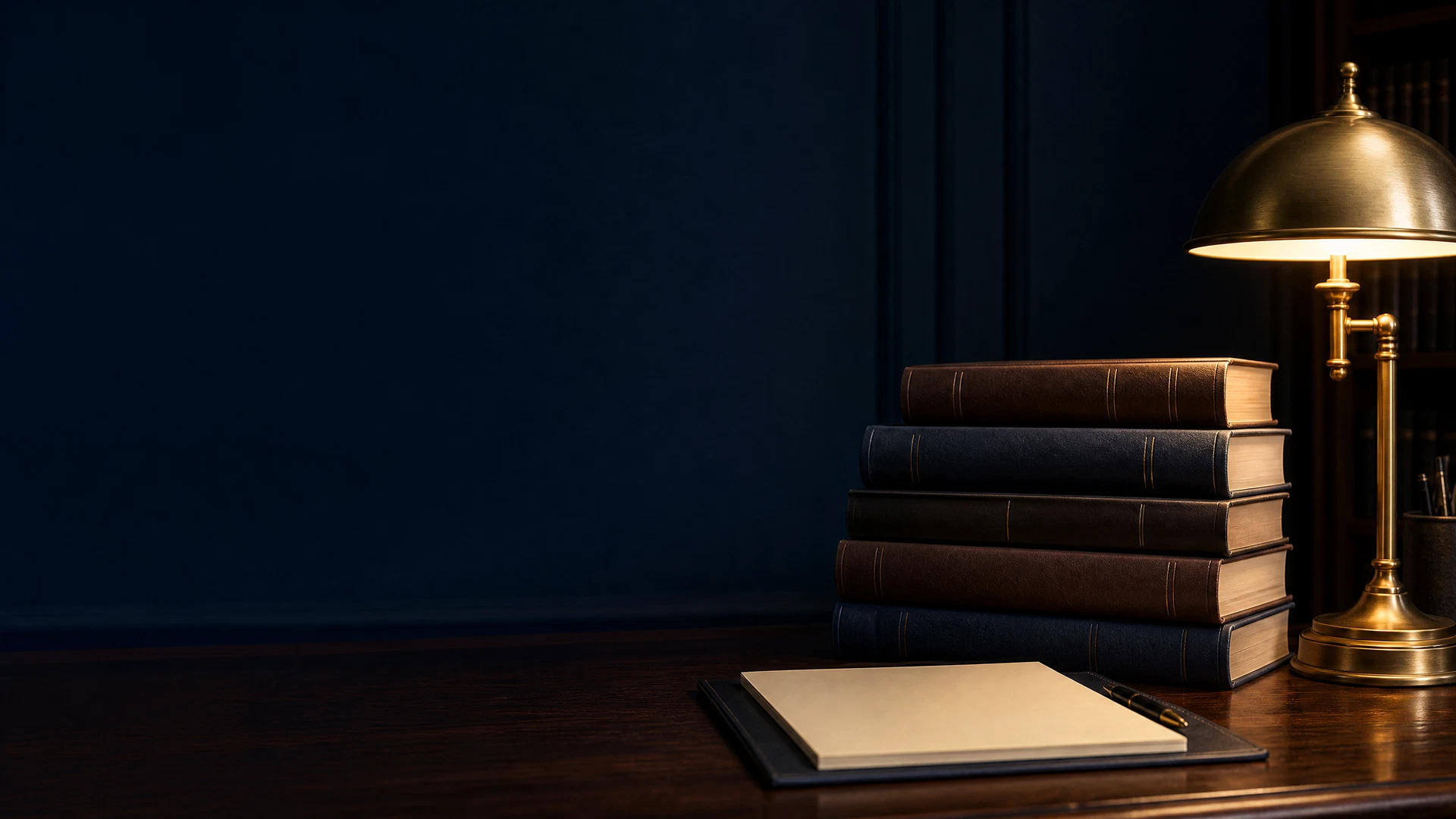 Legal reference books and a warm desk lamp